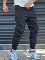 Jogger Utility – Black – worn – black cargo jogger pants with slanted zippered pockets and elasticated cuffs
