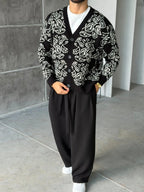 Gilet Triko Paisley – Noir – worn – full front view of model wearing black paisley knit cardigan sweater