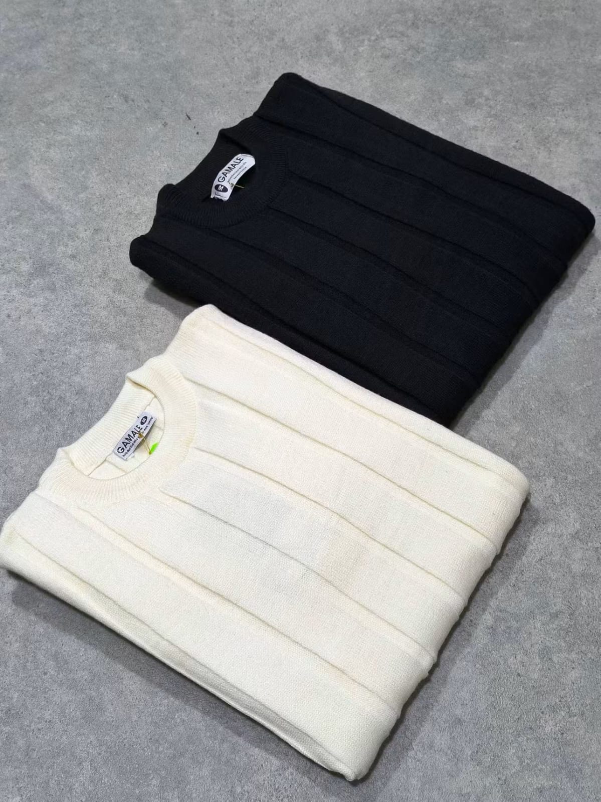 Trico Stripe Long – Blanc – flat – folded white and black sweaters featuring vertical rib knit structure