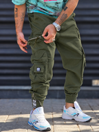 Jogger Pant Vibe – Green – worn – olive green cargo jogger pants with zipper detail and elastic cuffed hems