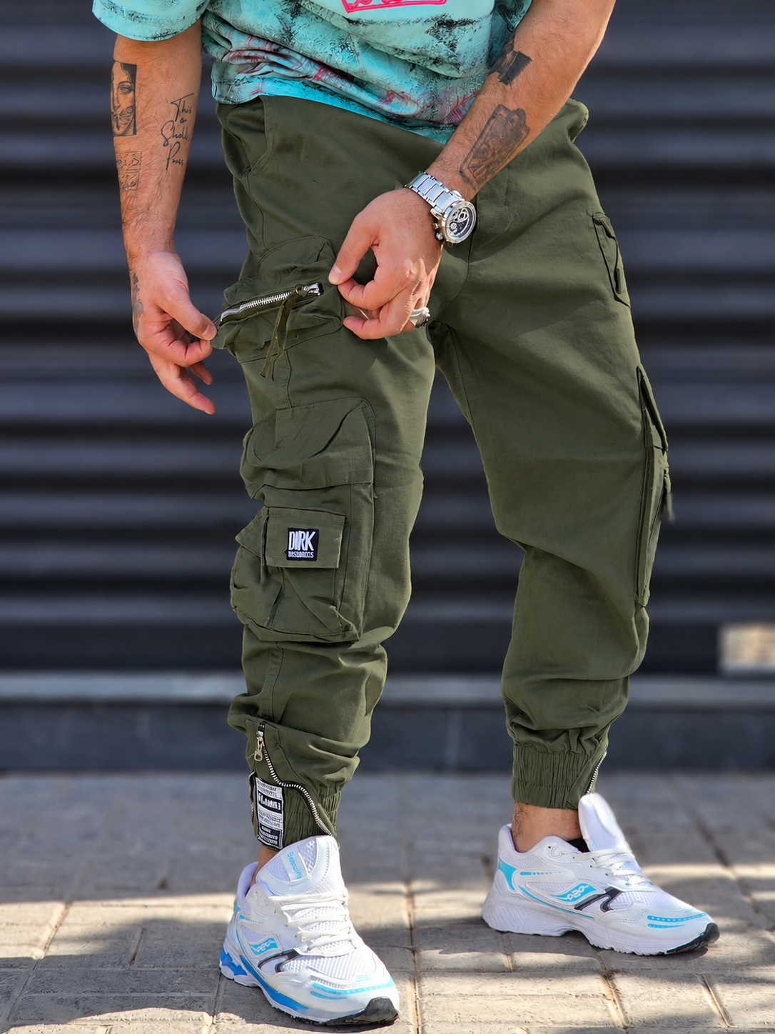 Jogger Pant Vibe – Green – worn – olive green cargo jogger pants with zipper detail and elastic cuffed hems