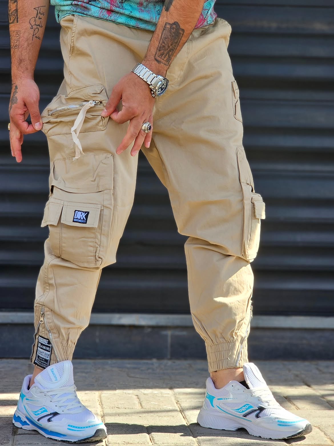 Jogger Pant Vibe – Beige – worn – beige cargo jogger pants with multi-pockets, ankle zips, and elastic cuffs